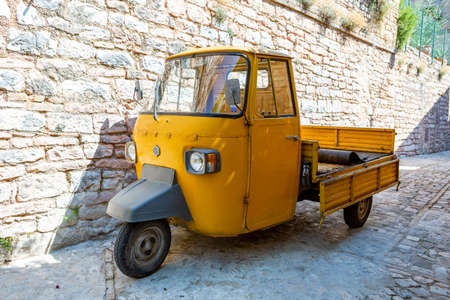 A old yellow tricycle Car is a three-wheeled light commercial vehicle produced since 1948 in Italyのeditorial素材
