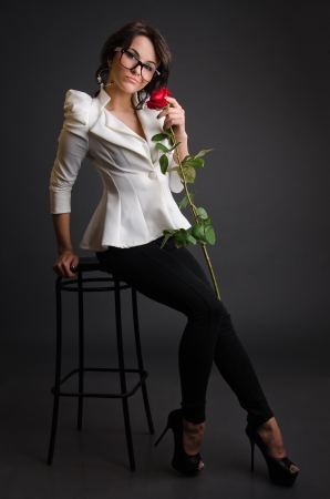 Girl with a rose in a white jacketの写真素材