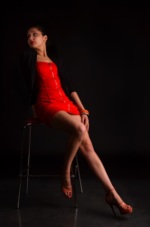 stylish brunette in a chair in the studioの写真素材