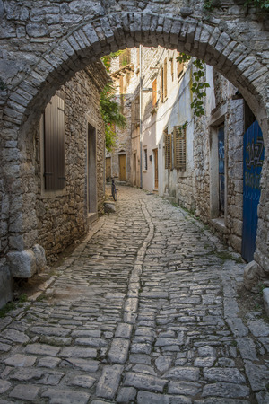 Old and narrow street, paved of cobble stones, in Bale town, Istria, Croatiaの写真素材
