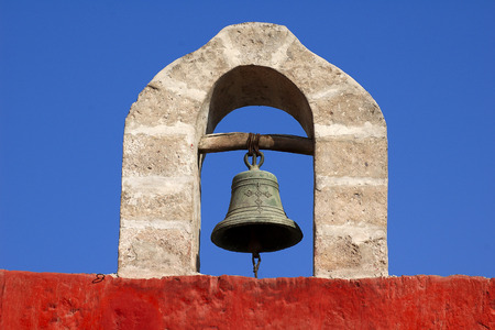 An ancient bell hanging on the stone archの写真素材