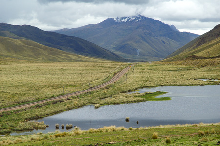 Endless pampas with and indigenous houses and mountainsの写真素材