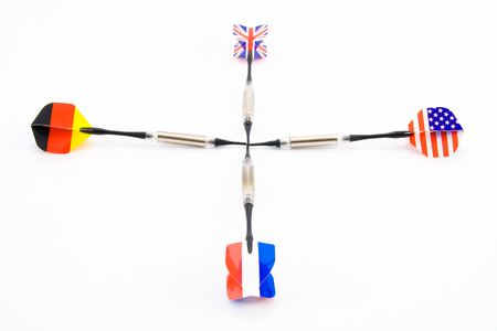 Detail of four different darts making cross. Isolated.の写真素材