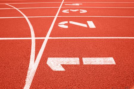 Close up of numbers on red running track.