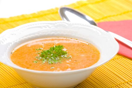 Tasty kohlrabi soup on orange table cover.の写真素材