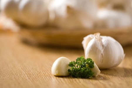Garlic on a wooden table with decoration. Shallow dof.の写真素材
