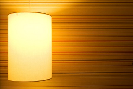 Lamp on a textured wallpaper shining. Including copy space.の写真素材