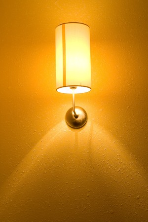 Lamp on a wall shining. Including copy space.の写真素材