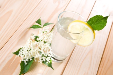 Healthy elder flower juice with lemon on wooden background.の写真素材