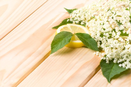Healthy elder flower with lemon on wooden background.の写真素材
