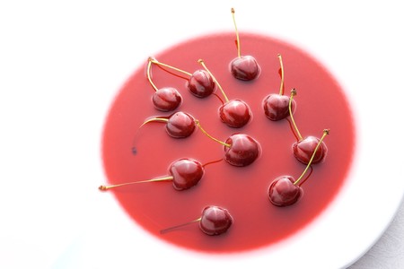 Cherries on plate as decoration - cherry soup.の写真素材