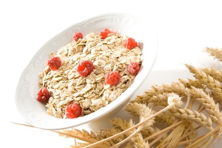 Bowl of wheat cereal with fresh raspberries.の写真素材