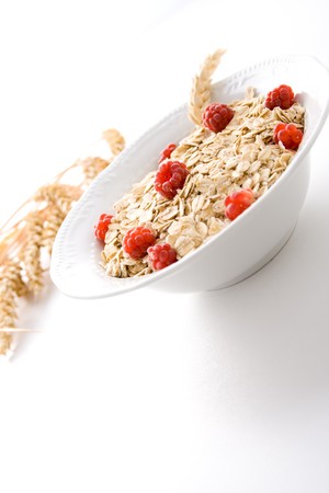 Bowl of wheat cereal with fresh raspberries.の写真素材