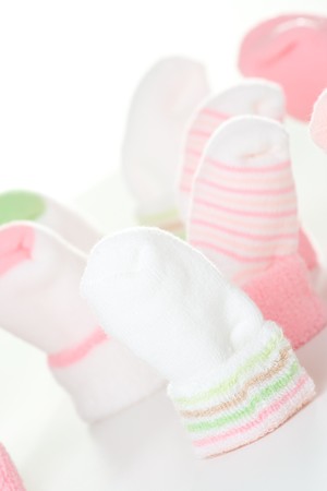 Many different green and pink socks for baby.の写真素材