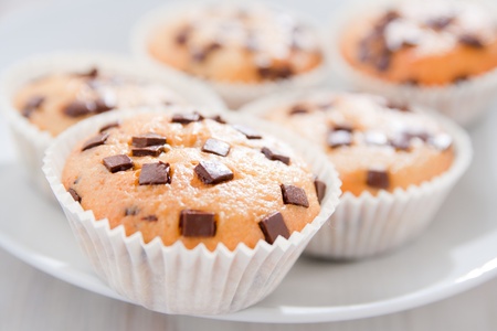 Many fresh and tasty home baked chocolate muffins on plate. の写真素材