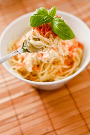 Spaghetti with vegetables, feta cheese and basil.の写真素材