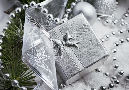Silver gift box and christmas decoration in snowの写真素材