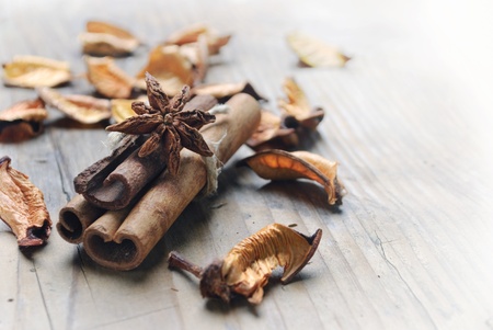 Cinnamon and anise seed on wooden plankの写真素材