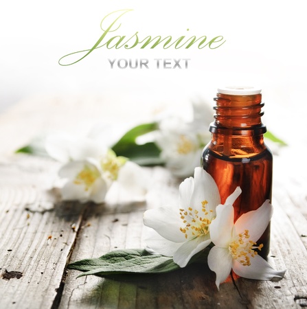 Essential oil with jasmine flower on wooden plankの写真素材