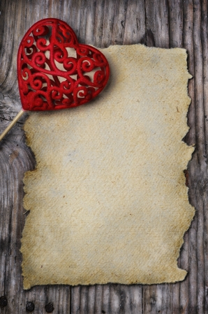 Valentine heart and old empty page on wooden backgroundの写真素材