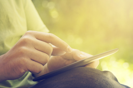 Man holding tablet in the parkの写真素材