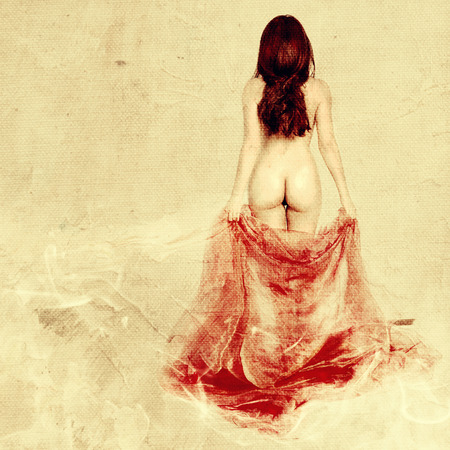 Beautiful naked woman with red silkの写真素材