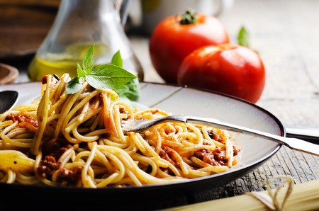 Italian spaghetti on rustic wooden table Italian spaghetti on rustic wooden table