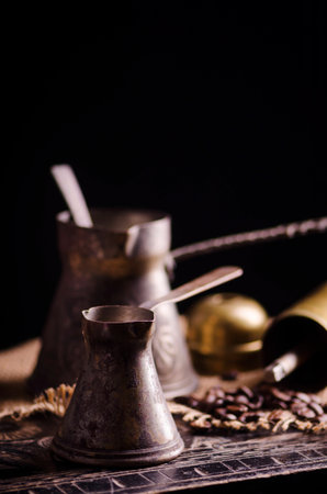 Vintage oriental coffee pot on rustic wooden tableの写真素材