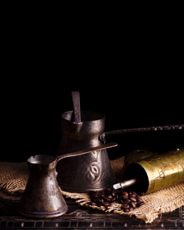Vintage oriental coffee pot on rustic wooden tableの写真素材