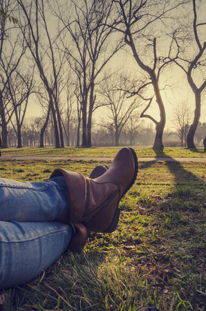Woman in boots resting in natureの写真素材