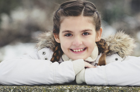 Portrait of young girl in winter jacket with fur.の写真素材