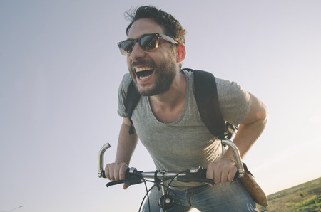 Man with bicycle having fun. retro style image.