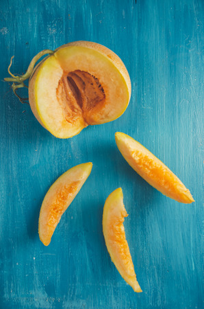 Melon slices on rustic blue backgroundの写真素材