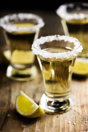 Tequila shots with salt on wooden table.の写真素材