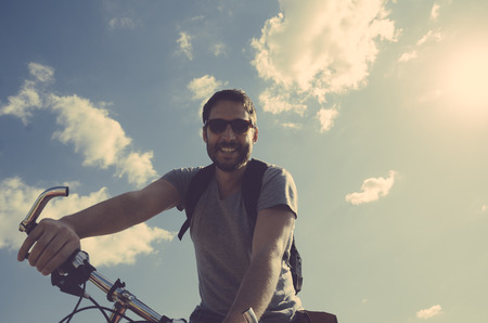 Man with bicycle having fun. retro style image.の写真素材