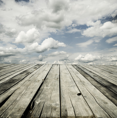 Rustic wooden planks and cloudy sky background design.の写真素材