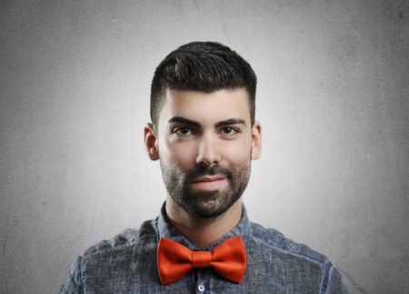Portrait of young handsome man with red bowtieの写真素材