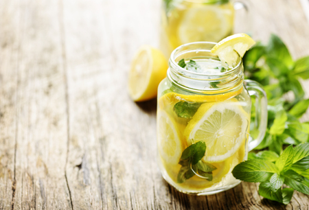 Mint lemonade in mason jars on rustic wooden table with copyspaceの写真素材