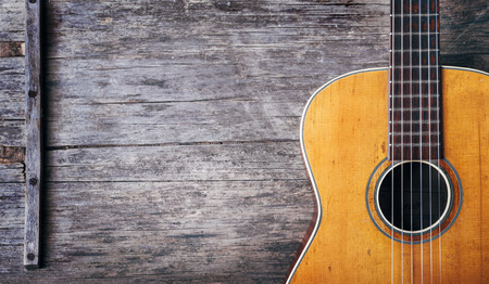 Closeup of old acoustic spanish guitar on rustic wooden  from above.の写真素材