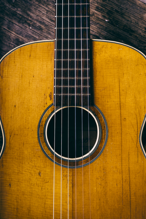 Closeup of wooden acoustic guitar from above.の写真素材