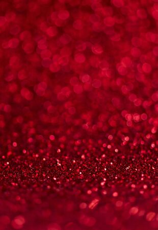 Abstract blur red glitter background card for Valentine's day, christmas and wedding celebration. Love bokeh sparkle confetti textured layout. Modern elegant design.の写真素材