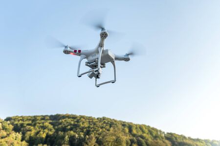 Drone with digital camera flying in the sky.