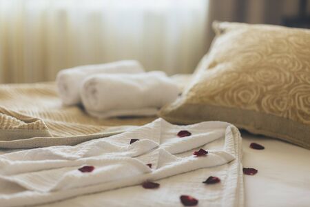 Luxury wellness and spa hotel room arranged for romantic weekend. Honeymoon suite bedroom decorated...