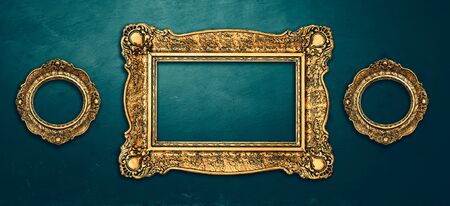 Vintage luxury golden frames set with ornate baroque decoration on rustic textured wall background. Retro fancy picture frames for interior design.の写真素材