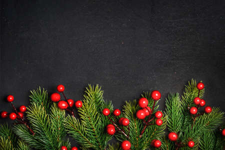 Christmas background border with christmas pine tree decor on vintage dark table. Top view. Winter...