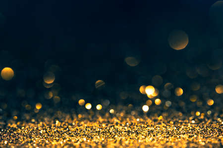 Luxury abstract glitter bokeh background. New year and christmas holiday party design. Golden star...