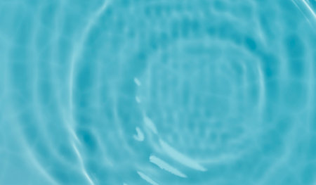 Blue water ripple texture from above. Top view of pool water surface with caustics. Tropical summer...