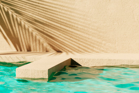 Tropical summer background with concrete wall, pool water and palm leaf shadow. Luxury hotel resort exterior for product placement. Outdoor vacation holiday house scene, neutral architecture aestheticの写真素材