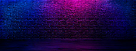 Neon brick wall textured background. Grunge interior room with led lights.の写真素材
