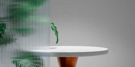 Empty marble table and monstera leaves behind textured glass panel. Home interior showroom background.の写真素材